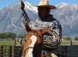 Cowboy on a horse swinging a lasso